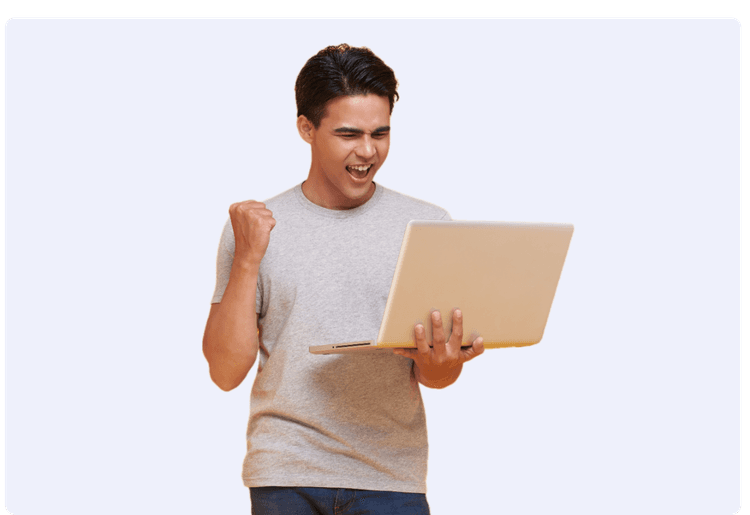 excited man looks at his laptop